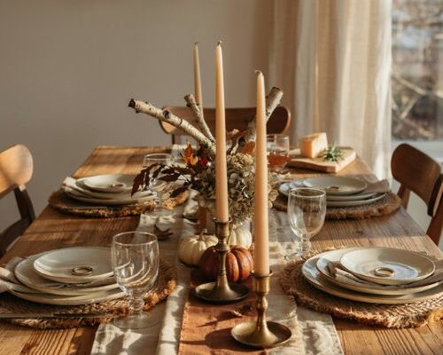 Fall dining table decor with moody colors warm candles rustic textures and layered autumn accents