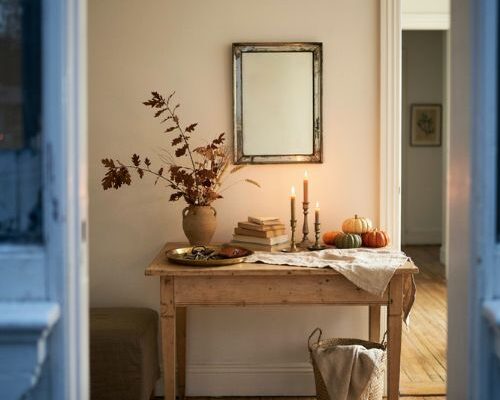 Fall entry table decor with pumpkins candles dried branches and warm autumn colors