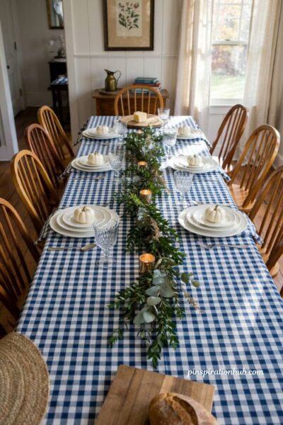 Fall table decor ideas with blue gingham white pumpkins and boxwood garland