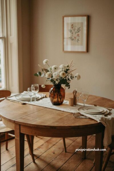 Fall table decor ideas with one brown glass vase and white flowers for an elegant simple centerpiece