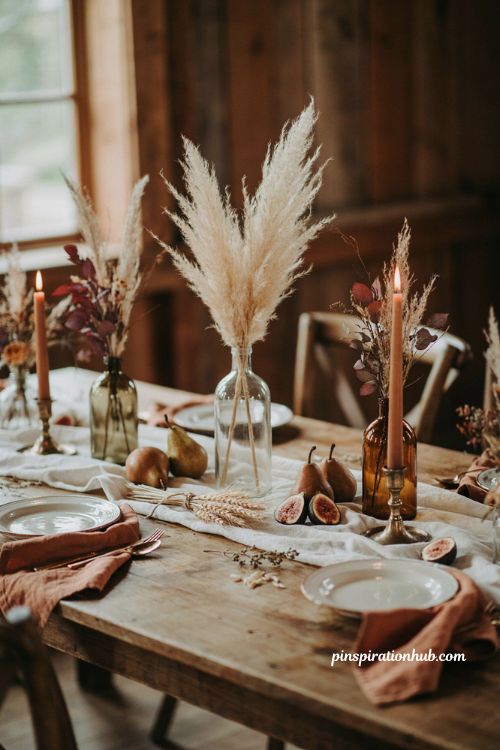 Fall wedding table decor ideas with pampas grass wheat vintage bottles candles and seasonal fruit