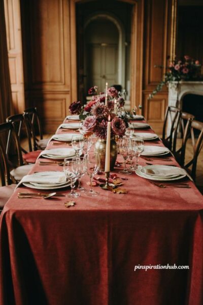 Fall wedding table decor with burgundy dusty rose flowers gold vase and candlelight