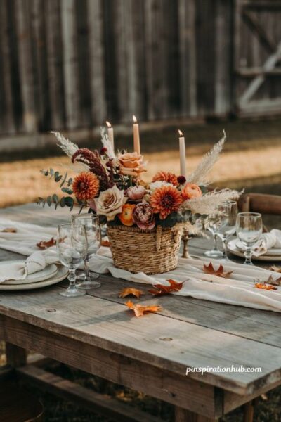 Fall wedding table decor with wicker basket floral centerpiece rustic flowers and farmhouse style
