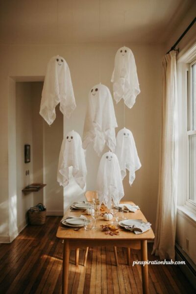 Floating cheesecloth ghost Halloween apartment decor over dining table