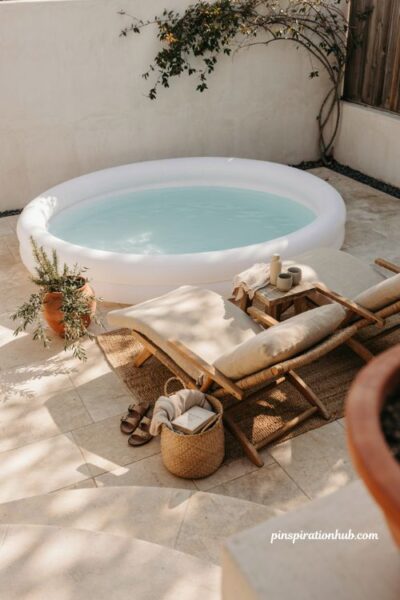 Inflatable pool with lounge chairs neutral cushions and cozy backyard decor