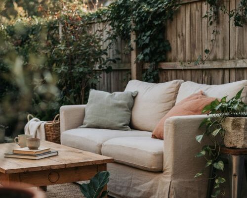 Layered texture cozy backyard ideas with rugs cushions wood and stone