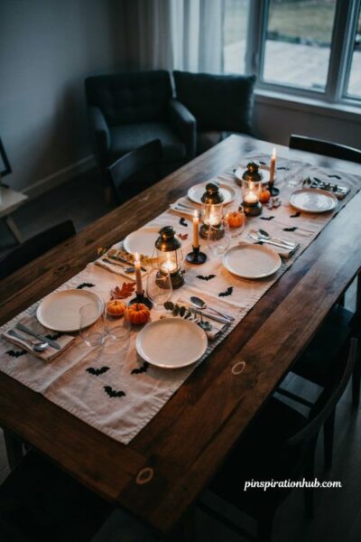 Moody Halloween table with draped black gauze and dark florals