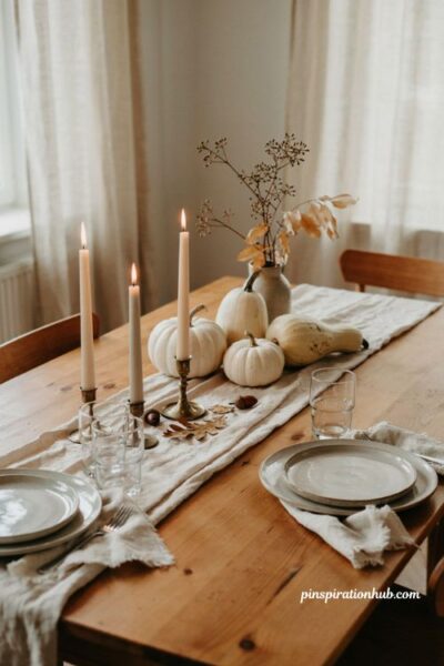 Neutral Halloween table runner with white pumpkins and candles