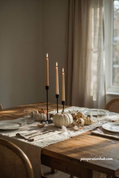 Neutral black and white Halloween tablescape with white pumpkin and black candlesticks