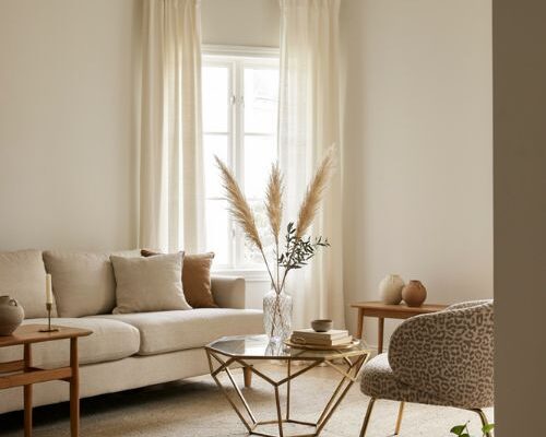 Neutral living room with gold coffee table brass accents and subtle glam decor