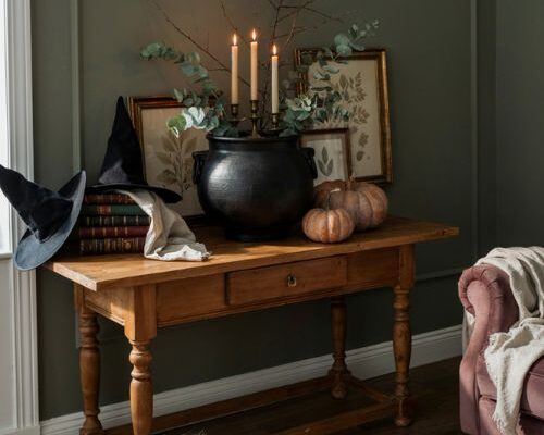 Witchy Halloween decor with cauldron witch hats and dark academia style